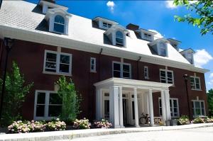 a large red brick house with a white roof at The George Montclair in Montclair
