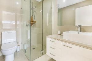 a bathroom with a shower and a toilet and a sink at Salt 13 Luxury Apartment in Sorrento +3 photos