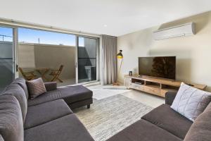 a living room with a couch and a flat screen tv at Salt 13 Luxury Apartment in Sorrento
