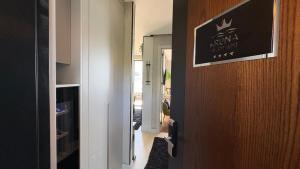 a hallway with a door with a sign on it at KRUNA 406 Apartment in Becici