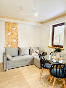 a living room with a couch and a table at Villa Kaplowa Chata & SPA in Zakopane