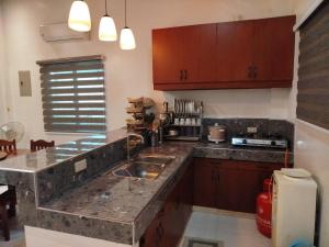 a kitchen with a sink and a counter top at Matthew's Tranquil Homestay in General Luna +3 photos