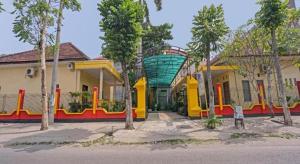 a group of buildings with trees in front of them at Collection O 90693 ORCHID EDOTEL Boyolangu in Tulungagung