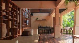 a living room with a table and a desk at The Spa Resorts - Lamai Village in Ban Thung