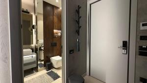 a bathroom with a toilet and a sink and a mirror at KRUNA 406 Apartment in Becici