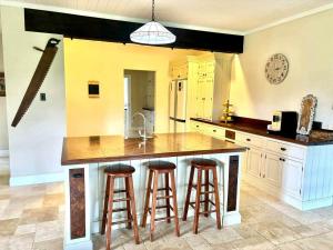 een keuken met een groot eiland met barkrukken bij Little River Valley in Denmark
