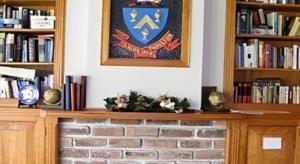 a brick fireplace with a picture on the wall at Fletcher Christian Holiday Hotel in Kingston +125 photos