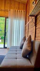 a bed with two pillows in a room with a window at Sapa Retreat Homestay & Restaurant in Lao Cai
