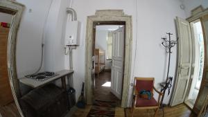 a hallway with a mirror and a chair in a room at Hostel MIF in Ivano-Frankivsk