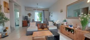a living room with a couch and a table at Aegean Villa in Artemida