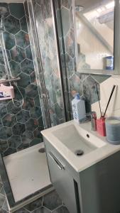 a bathroom with a sink and a mirror and a shower at Quiet Loft Double Room forty-five minutes by train to London Liv Street in Braintree