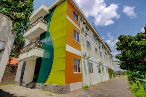 a building with a rainbow painted on the side of it at Collection O near Stadion Manahan formerly Graha Laweyan Solo in Bonorejo