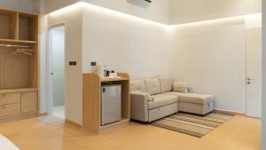 a living room with a couch and a chair at rimbaymangrove resort in Ban Khlong Tamru