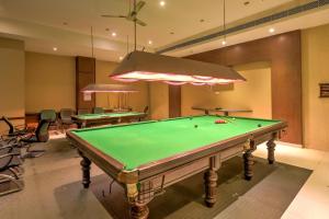 a billiard room with a pool table and chairs at Townhouse Kakinada Nagamalli Thota Junction in Kākināda