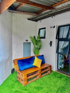 a bench with a blue and yellow pillow on the grass at Craftsmanship 340 IMD in Johannesburg