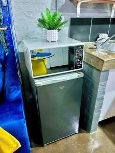 a small kitchen with a microwave and a sink at Craftsmanship 340 IMD in Johannesburg