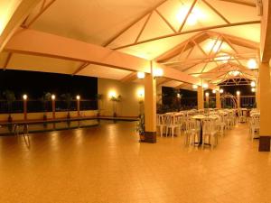 a banquet hall with white tables and white chairs at Li Hua Hotel Bintulu in Bintulu