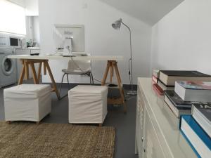 an office with a desk and a computer on a table at Atouguia Apartment in Funchal