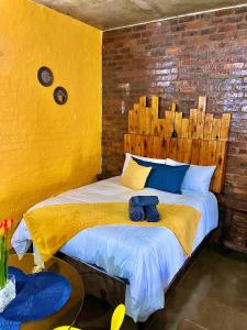 a bedroom with a bed with a wooden headboard at Craftsmanship 340 IMD in Johannesburg