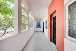 an empty hallway of a house with windows at Collection O Hyderabad Hitech City Formerly Night Eye in Hyderabad