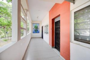 a corridor of a house with orange and white walls at Collection O Hyderabad Hitech City Formerly Night Eye in Hyderabad +23 photos