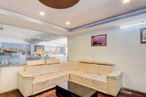 a living room with a couch and a table at Collection O Hyderabad Hitech City Formerly Night Eye in Hyderabad