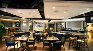 a restaurant with tables and chairs in a room at Kingwood Boutique Hotel in Miri