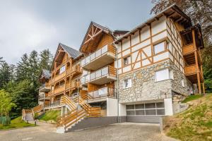 a large house with stairs up to it at Apartament Widokowy Karpacz z garażem i widokiem na góry, blisko szlaki i centrum in Karpacz
