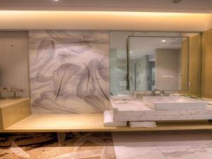 a bathroom with a sink and a large mirror at Qingdao Tired Bird Hotel in Qingdao +126 photos