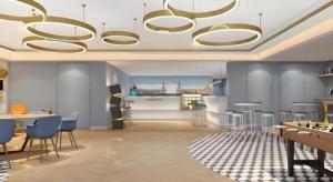 a room with tables and chairs and a chandelier at Magnotel Harbin Medical University First Affiliated Hospital in Harbin