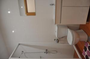 a bathroom with a tub and a toilet and a cabinet at Casa Mao-Cheia in Arco da Calheta +40 photos