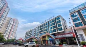 a large building in the middle of a city at Borrman Hotel Wuxi Hubin Business Street in Wuxi