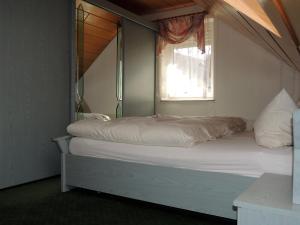 Postel nebo postele na pokoji v ubytování Gästehaus Am Hirtenberg