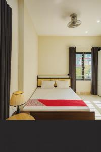 a bedroom with a bed with a red blanket at Dũng Quyến Homestay in Da Nang +15 photos