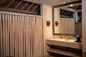 a bathroom with a sink and a mirror at Nomadic Resort Bali in Canggu +81 photos