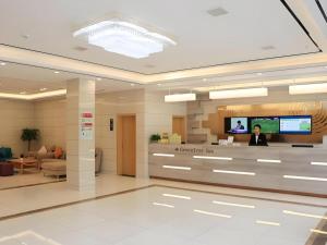 a lobby of a hospital with a tv on the wall at GreenTree Inn Huangshi Huahu Development Zone Daquan Road in Huangshigang