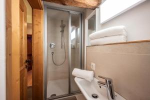 a bathroom with a shower and a sink at Berg'k'hof Kaisertal - Alpine Hideaway in Ebbs