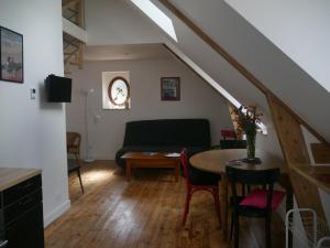 a living room with a table and a couch at Tagar'étape in Étables-sur-Mer