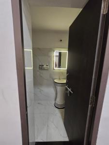 a bathroom with a toilet and a sink at Kassy homestay in Udaipur