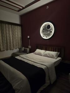 a bedroom with two twin beds and a moon at Kassy homestay in Udaipur +4 photos