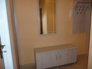 a bathroom with a dresser and a mirror on the wall at Apartament Andre in Gdynia