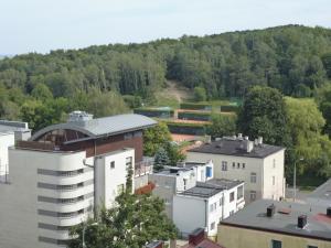 a group of buildings with a mountain in the background at Apartament Andre in Gdynia