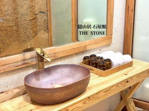 a bathroom with a wooden sink and a mirror at 隱山居 海景包棟2-10人 in Jiufen +35 photos