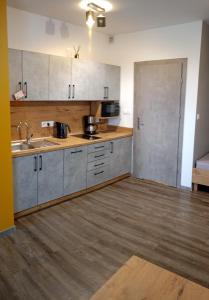 an empty kitchen with a sink and a refrigerator at Apartament Ksawery parking w cenie podgrzewany basen in Rewal