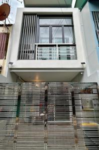 a building with a window and a metal gate at Cozy Nest Ladprao - 3BR Townhome 3min walk from MRT in Bangkok