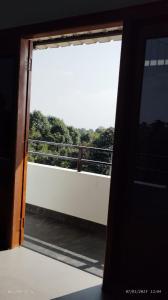 an open door with a view of a balcony at Riwai Root Bridge homestay in Mawlynnong