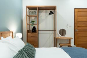 a bedroom with a bed and a book shelf at Cozy Nest Ladprao - 3BR Townhome 3min walk from MRT in Bangkok