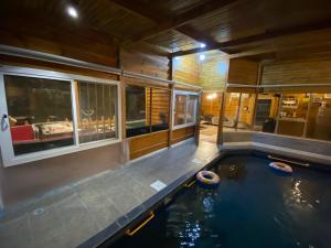 a house with a swimming pool in the middle at كوخ الوهط الريفي in Taif