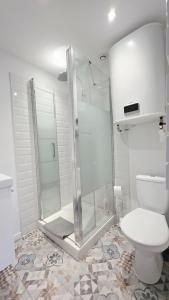 Un baño blanco con ducha y WC. en Intimissime, en Dunkerque