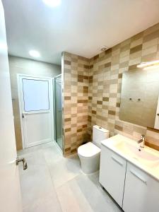 a bathroom with a toilet and a sink and a shower at Lux Hostal in Hospitalet de Llobregat